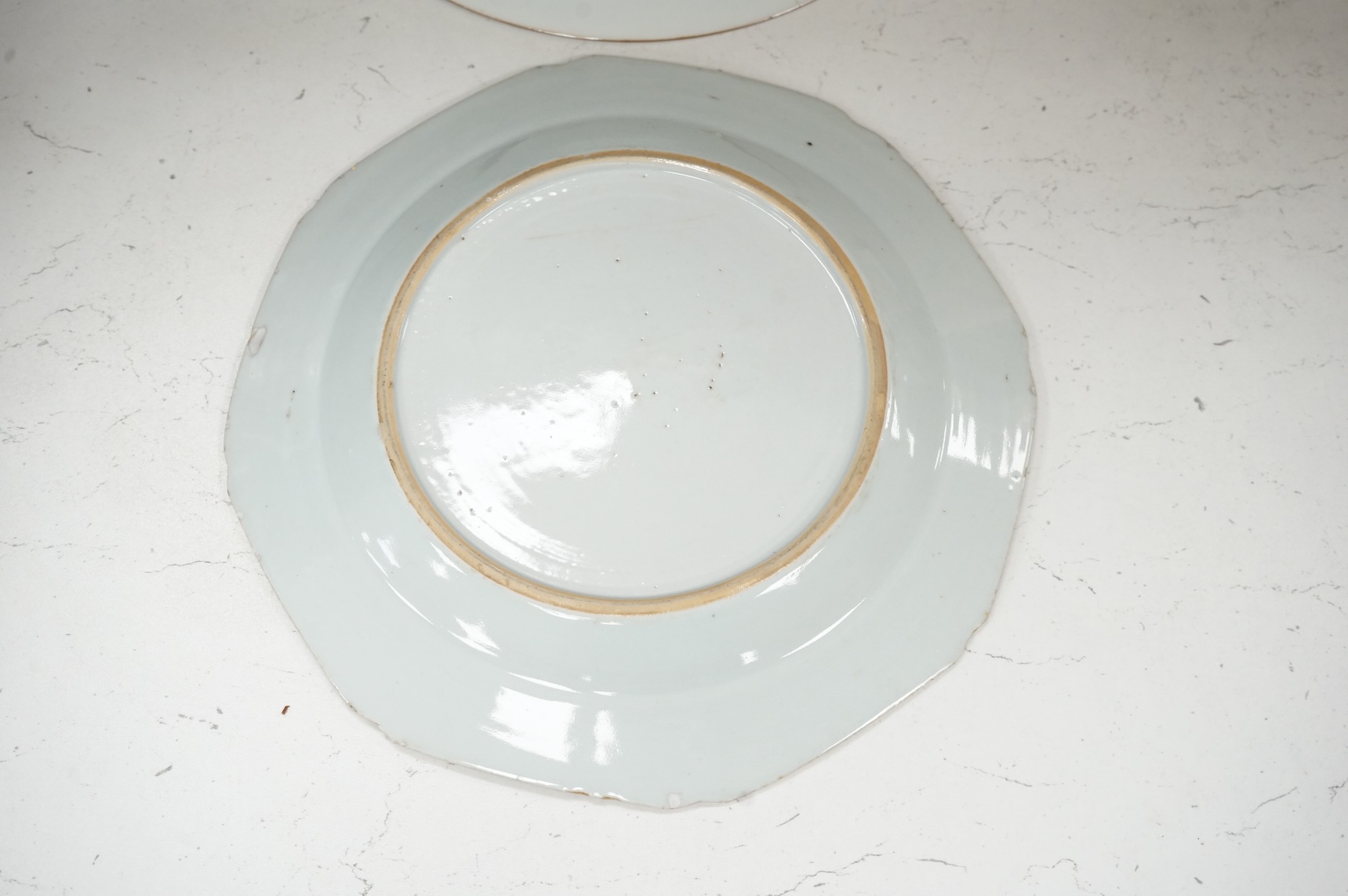 Three Chinese famille rose plates, Qianlong, including an armorial example, largest 22.5cm in diameter